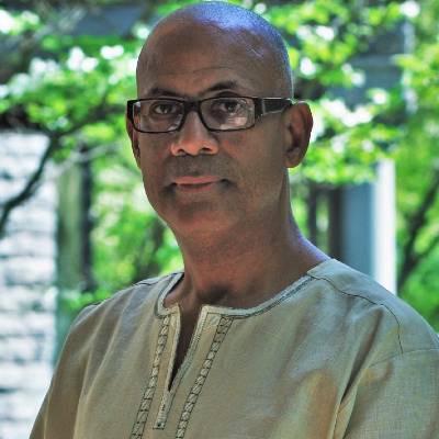 Shawn Utsey, Ph.D., in front of greenery