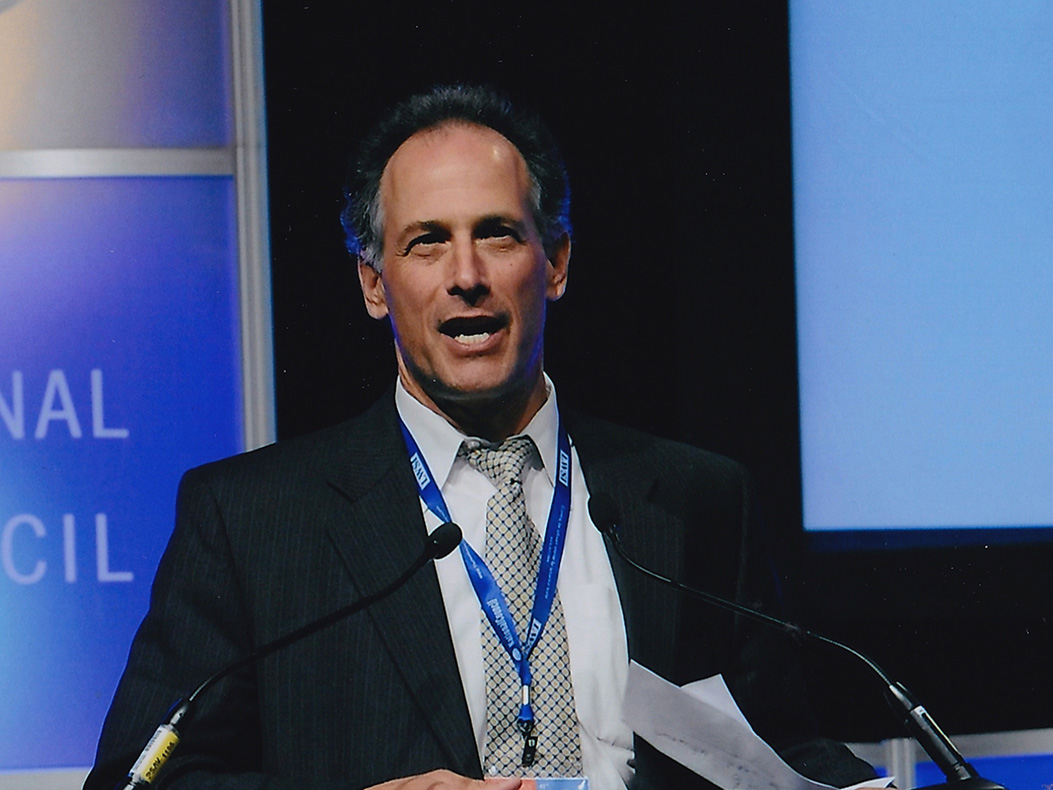 Peter Zucker speaking at a podium